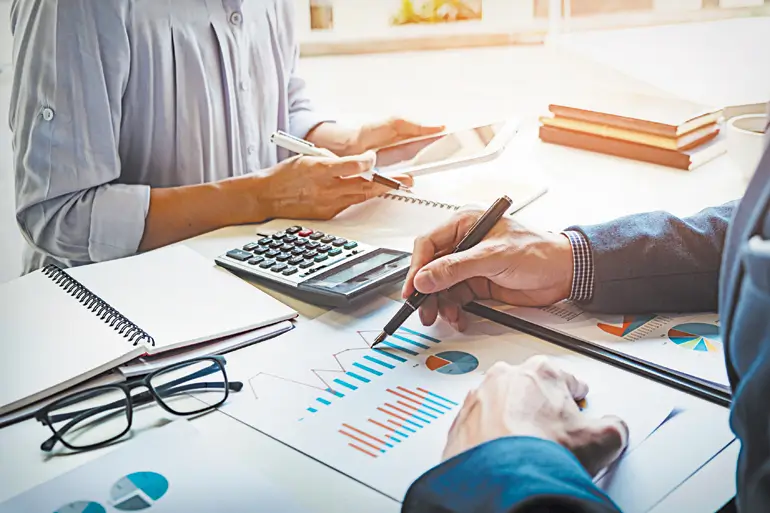 Co-workers working on a business plan while in office