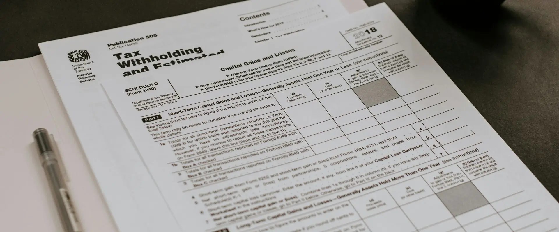 Corporation tax stack of papers being laid out on the desk