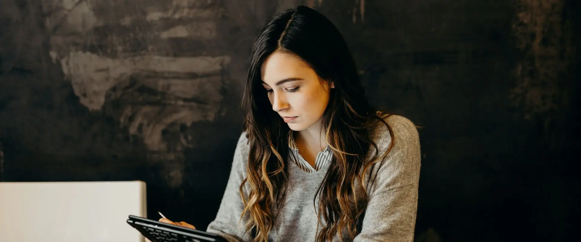 Payroll options for your business Young female business owners going through her employee payroll on her tablet.