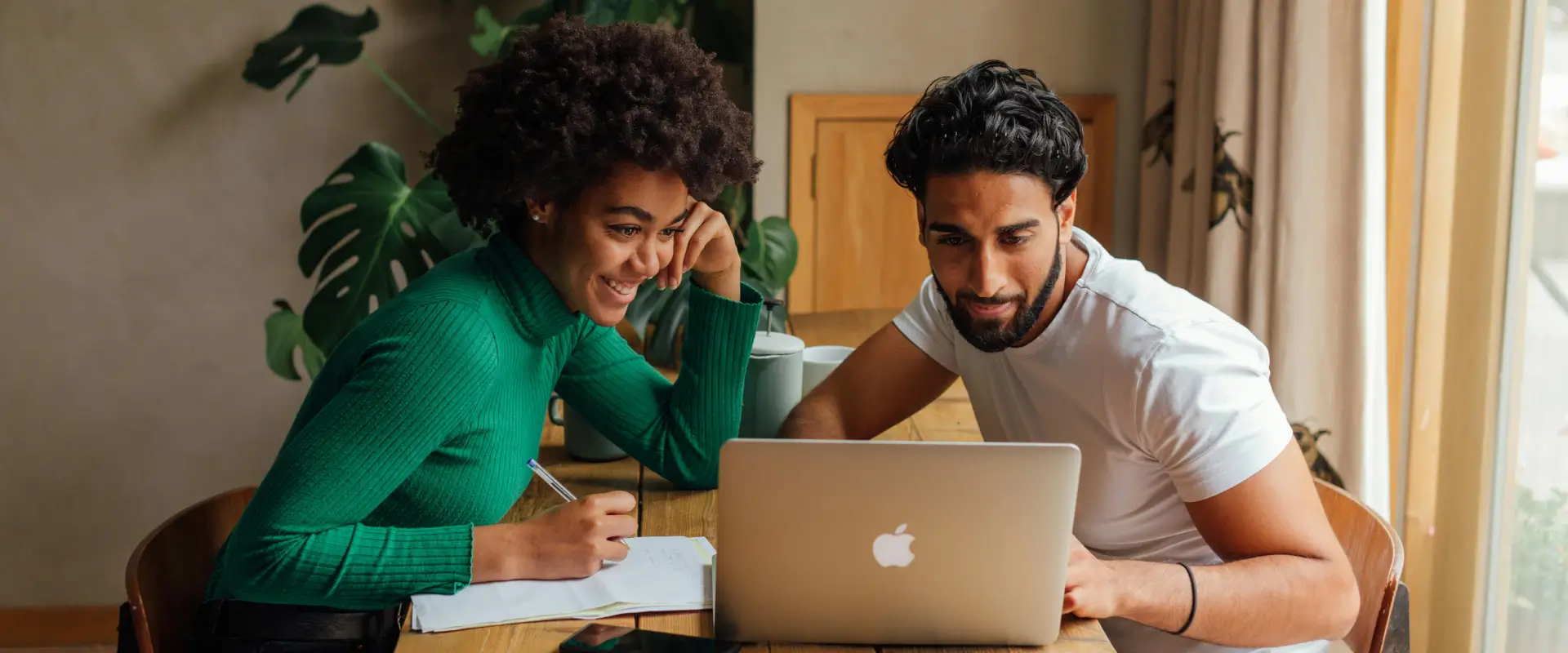 Couple searching for Accountants near me on laptop